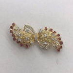 Alloy brooch with ruby and clear crystal in gold plating